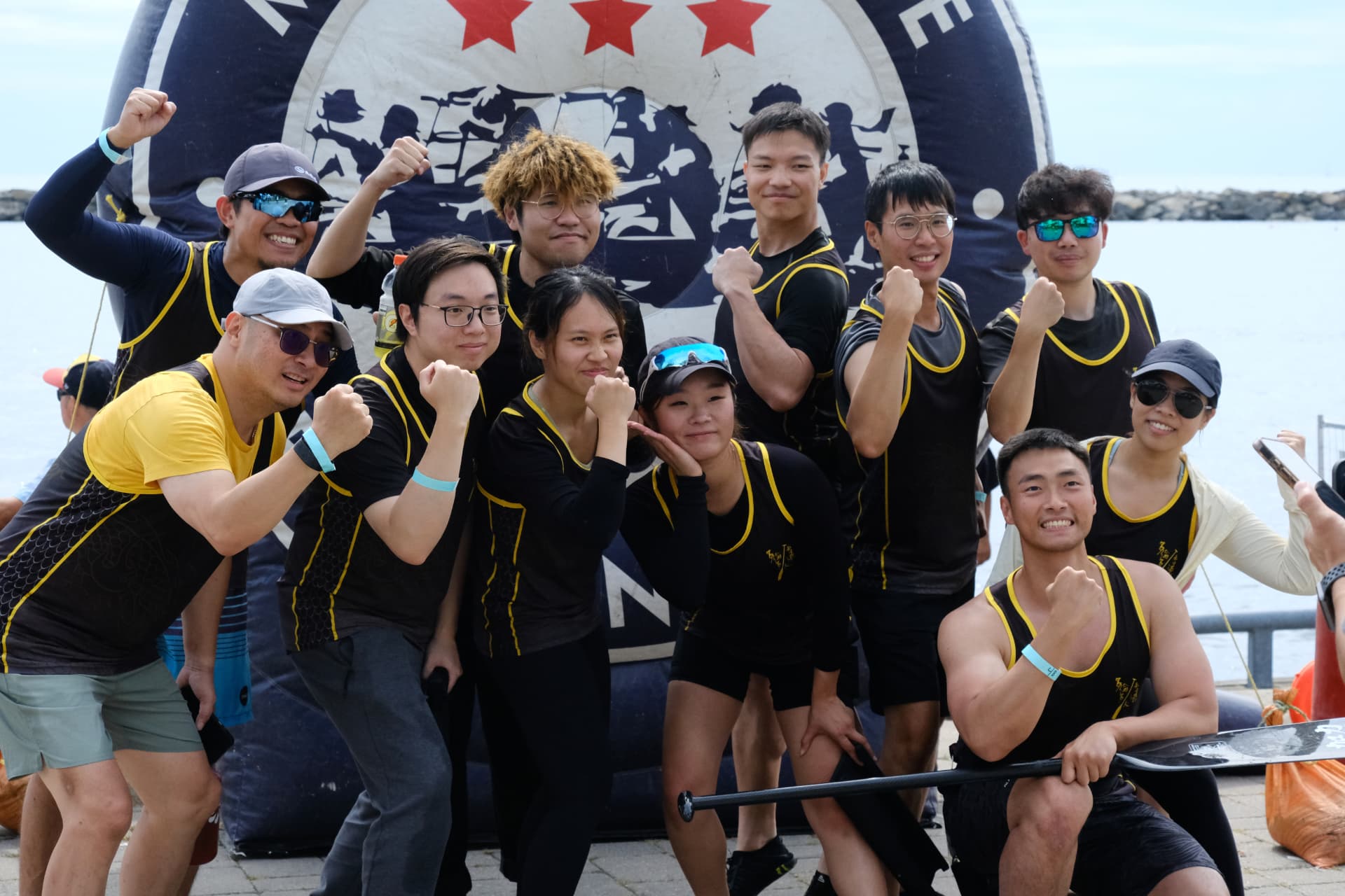 TOHK crew cheering in front of the regatta arch