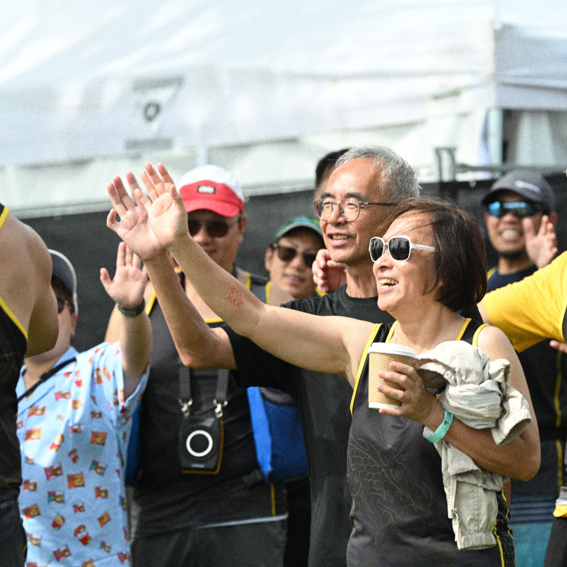 TOHK supporters waving and cheering from the shore