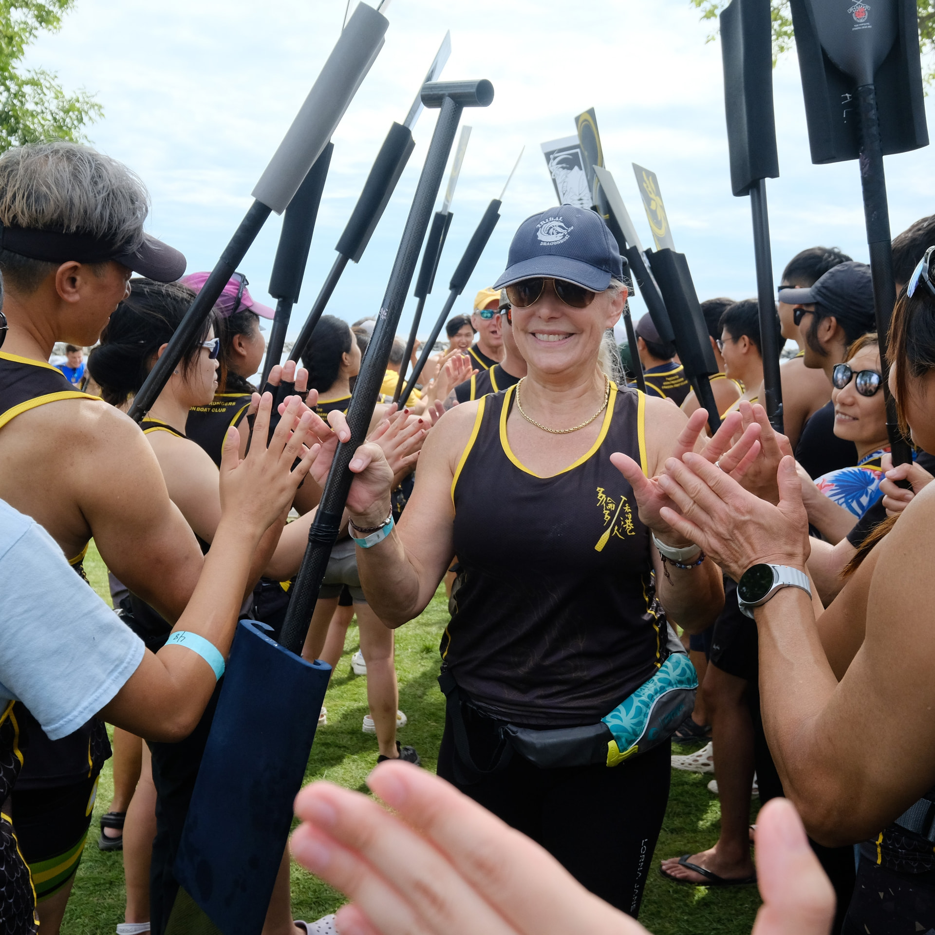 TOHK paddlers cheering through a double high-five line